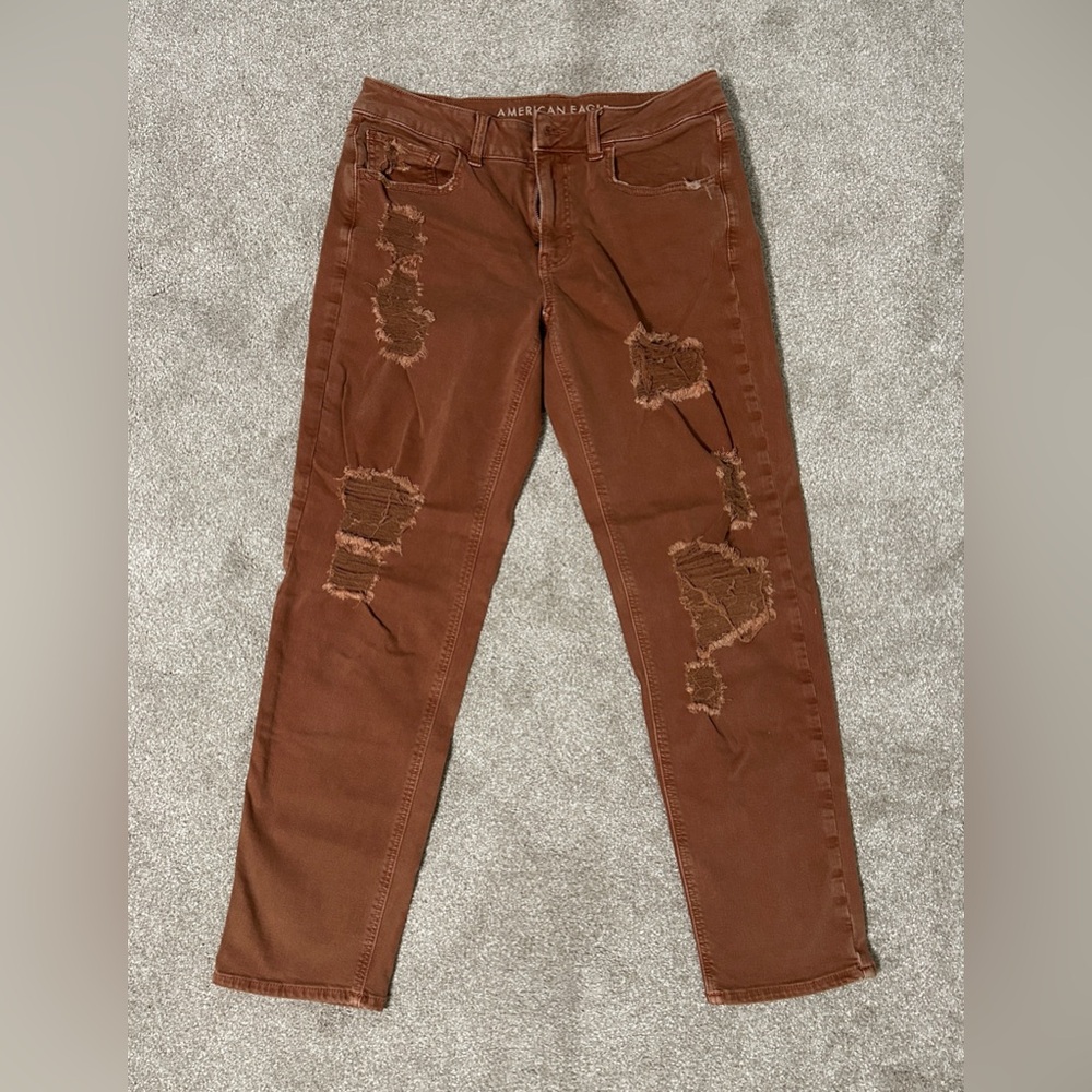 AE distressed orange-rust colored jeans